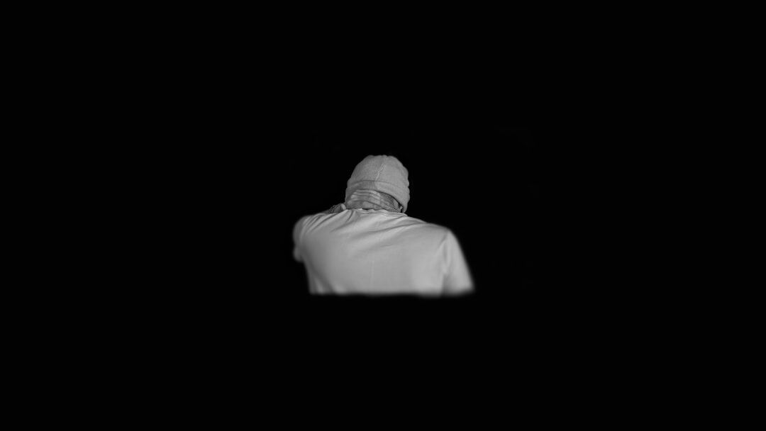 White humanoid robot with glowing eyes on dark background